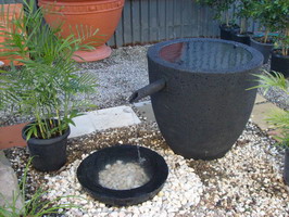 black volcanic scoria water feature pot with japanese style spout and bowl