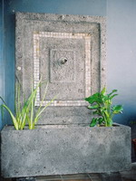 Custom volcanic scoria water feature troughs and spouts with travertine tile inserts, charcoal finish